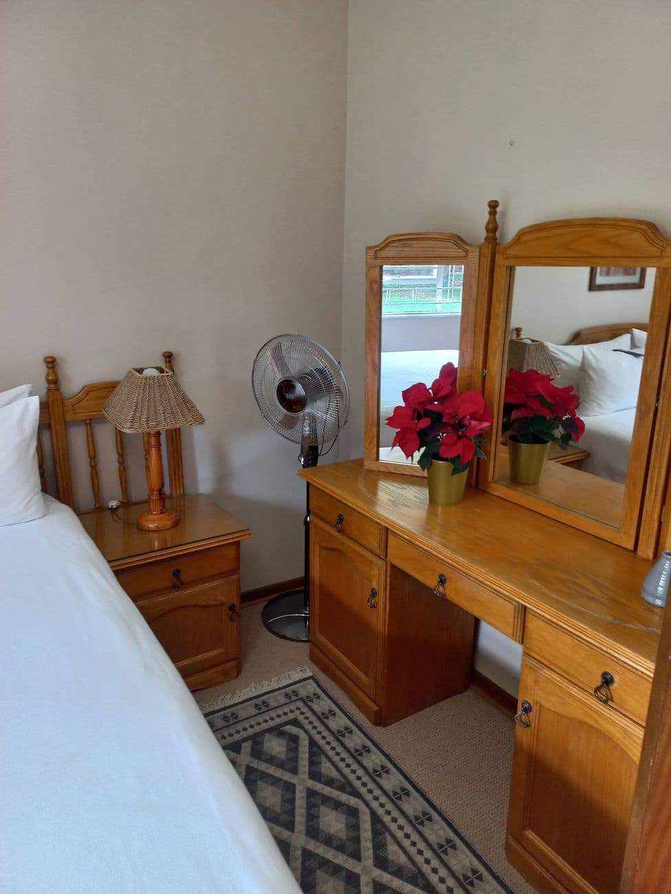 A room vanity with fresh flowers at Oase Guesthouse