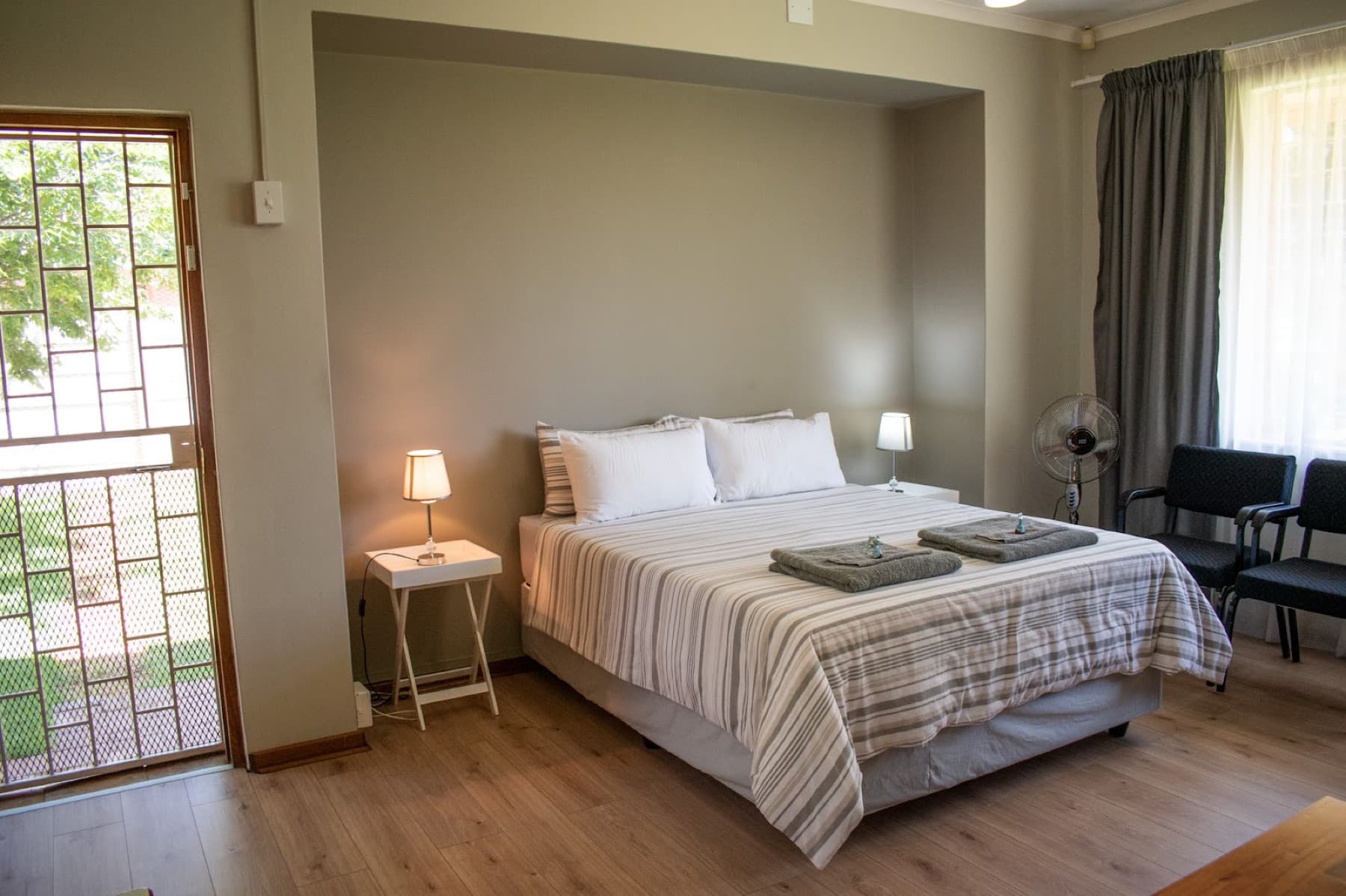 A guest room at Oase Guesthouse opening onto the garden, Hennenman